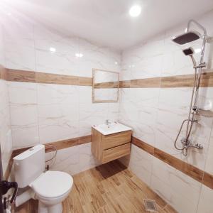 a bathroom with a toilet and a sink at Къща за гости КрисиЯна in Zlatograd +16 photos