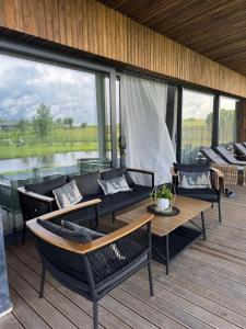 a screened in porch with couches and a table at Harmony Resort & Spa in Padumble