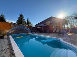 a swimming pool in front of a house at Violetta Cottage in Užice