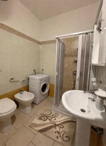 a bathroom with a toilet and a sink and a shower at Supera Home in Gallipoli +12 photos