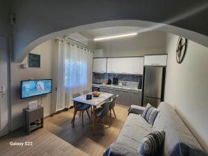 a living room with a couch and a table at Orange Grove in Plomari