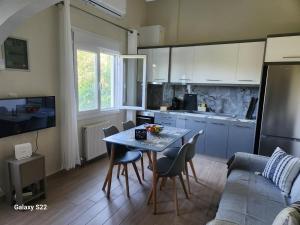 a kitchen and dining room with a table and chairs at Orange Grove in Plomari