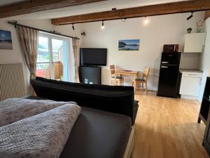 a bedroom with a bed and a dining room with a table at Ferienwohnung Wieser in Sankt Jakob in Haus