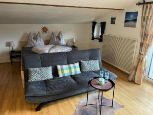 a living room with a couch and a bed at Ferienwohnung Wieser in Sankt Jakob in Haus