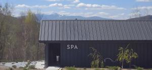 a black building with a sa sign on it at Domek SPA z sauną i jacuzzi - Level780 in Koszarawa