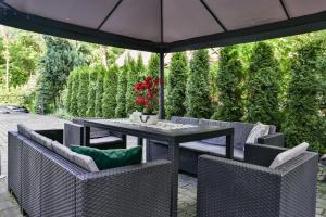 a patio with a table and chairs under an umbrella at Villa 33 in Zakopane
