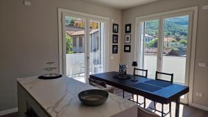 a kitchen with a table and a large window at Lake Como Terrace Suite in Mandello del Lario