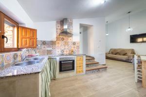 a kitchen with a sink and a counter top at Yerbaluisa in Laroya