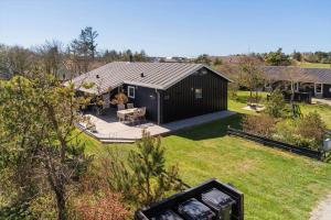 an aerial view of a black house with a yard at 136-Snedsted-Lykkens-Hab-23 in Snedsted