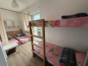 a room with two bunk beds and a window at Century hostel in Gdynia