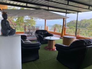 a room with couches and a table and a balcony at sunsetvilla studio in Saint-Martin