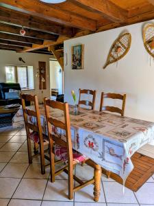 a dining room with a table with chairs at Gîte FRAIZE in Fraize