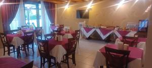 a restaurant with red and white tables and chairs at Agriturismo Aver in Villafranca di Verona