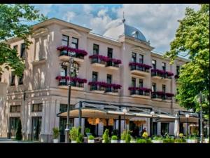 a large white building with flowers on the balconies at RELAX-zepter in Vrnjačka Banja