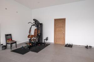 a room with a gym with a guitar machine at The Palm Oasis in Lamai