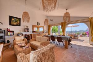 a living room with a table and chairs at Casa Azafranes - Boutique B&B - Arenas in Arenas