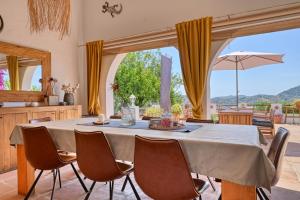 a dining room with a large table and chairs at Casa Azafranes - Boutique B&B - Arenas in Arenas