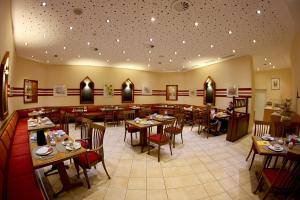 a dining room with tables and chairs in a restaurant at City Hotel Hannover in Hannover