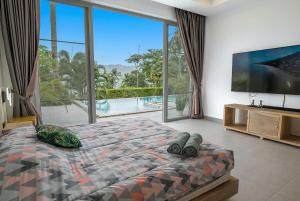 a bedroom with a large bed and a large window at The Palm Oasis in Lamai +41 photos