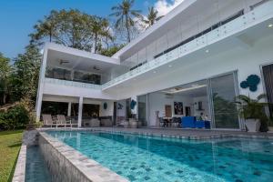 a villa with a swimming pool and a house at The Palm Oasis in Lamai