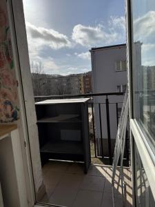 a balcony with a view of a building at Century hostel in Gdynia