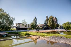 a house with a pond in front of it at The Larch House in Chester