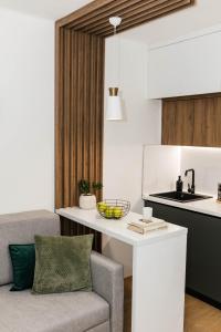 a kitchen with a table and a couch in a kitchen at Lorena 21 Central in Bileća +28 photos