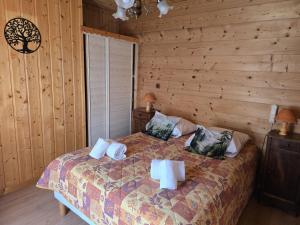 a bedroom with a bed in a log cabin at Les Touristes in Abondance