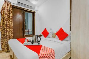 a room with two beds with red pillows at Hotel O Premium Inn in New Delhi