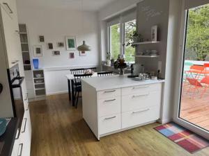 a kitchen with a white counter and a table at Petit Fleur in Marktleuthen
