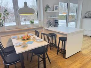 a kitchen with a table and chairs and a counter at Petit Fleur in Marktleuthen