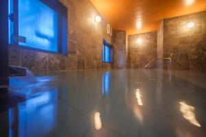 a bathroom with a marble floor in a room at Tabino Hotel EXpress Narita in Narita