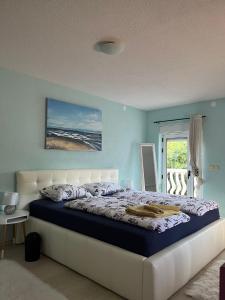 a bedroom with a large bed with blue walls at Ferienhaus Vedran in Vir