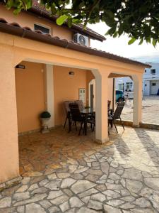 a patio with a table and chairs on it at Ferienhaus Vedran in Vir