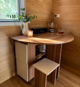 a kitchen with a wooden counter with a table at Kangaroo Island A-Frame Off-Grid Escape in Pelican Lagoon