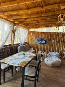 a dining room with a table and chairs at Каравана Мир in Chernomorets