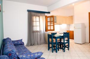 a living room with a couch and a table and a kitchen at Hotel Zefi in Syvota +30 photos