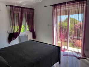 a bedroom with a bed and a large window at Villa Neyla Four bedroom Coral Bay Beach front in Coral Bay +55 photos
