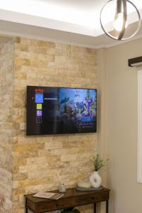 a flat screen tv on a stone wall at Elaya Experience in Kamisianá