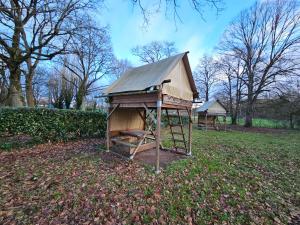 a small dog house with a ladder in a field at Camping Onlycamp Veuzain-sur-Loire in Veuzain-sur-Loire