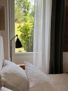 a bedroom with a bed and a window with a view at Clos Lujatis in Valençay