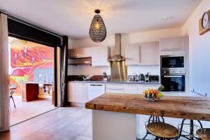 a kitchen with a counter with a bowl of fruit on it at PAPANG - House 148m 3rooms Jacuzzi in Saint-Leu