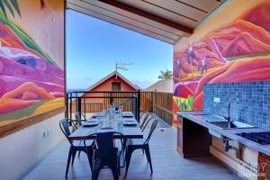a dining room with a table and a mural at PAPANG - House 148m 3rooms Jacuzzi in Saint-Leu +13 photos