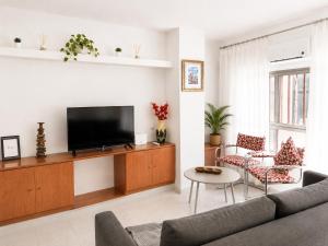 a living room with a couch and a tv at Alojamiento San Juan en Murcia Centro in Murcia