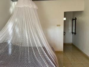 a bed with a net on it in a room at Tetebatu Fullmoon in Tetebatu
