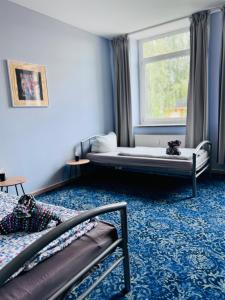 a bedroom with two beds and a window at Hostel in Böhlen
