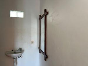 a bathroom with a sink and a mirror on the wall at Tetebatu Fullmoon in Tetebatu +59 photos