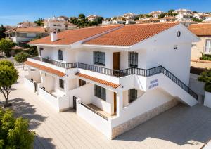 a white house with a red roof at Turyva Tarongers 1 - Modern 1-Bedroom Apartment Near the Beach, Costa del Azahar in Peniscola