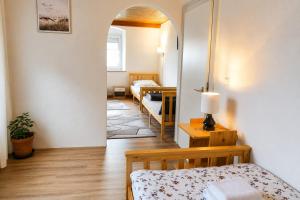 a room with two beds and a room with a mirror at Naab-burg in Nabburg