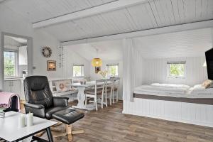 a white room with a bed and a dining room at 329-Thisted-Sandtornvej-21 in Thisted